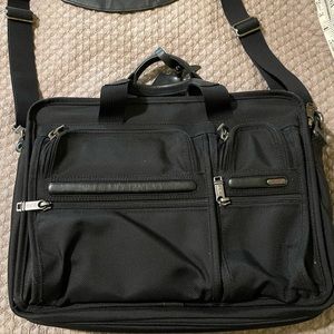 Tumi bag w expansion. Leather handles and shoulder strap. Hardly used